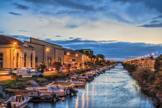 Moored boats along a canal at blue hour
