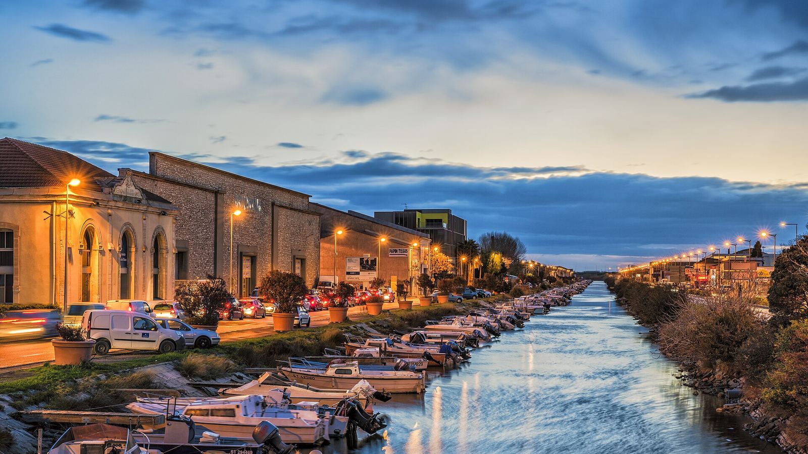 Moored boats along a canal at blue hour