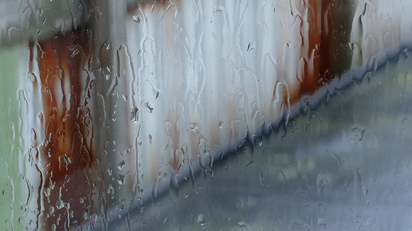 Rain running down a window pane