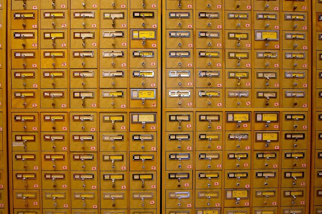 A wall of wooden card-catalogue drawers in a library