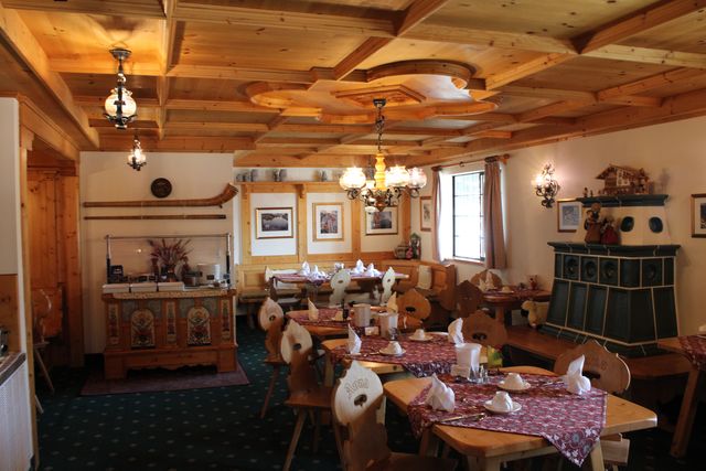 An empty hotel breakfast room with its tables laid