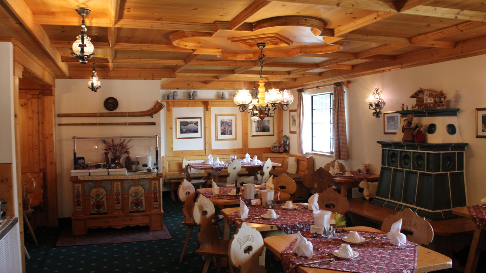 An empty hotel breakfast room with its tables laid