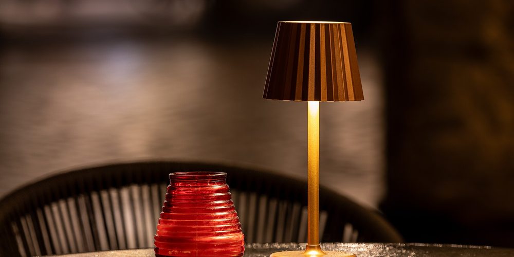 A small table lamp lit in a dark room