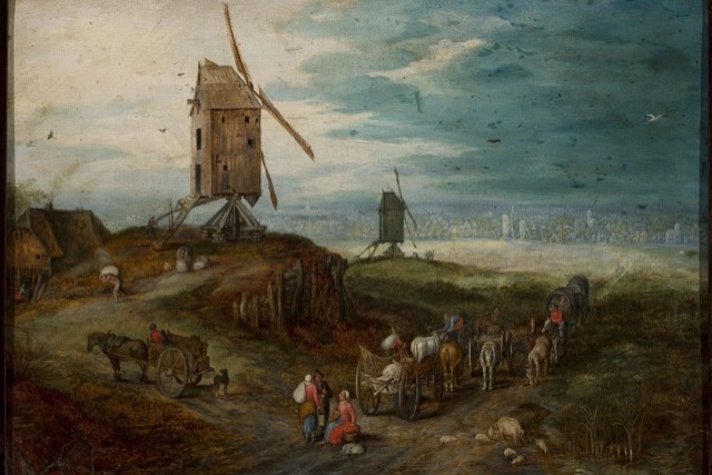 A Flemish country road with horse-drawn carts, walkers and pigs, a large wooden windmill on a hill and a wide plain with a distant town beyond.